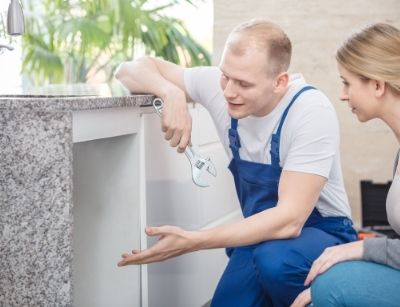 plumber gesturing to under sink